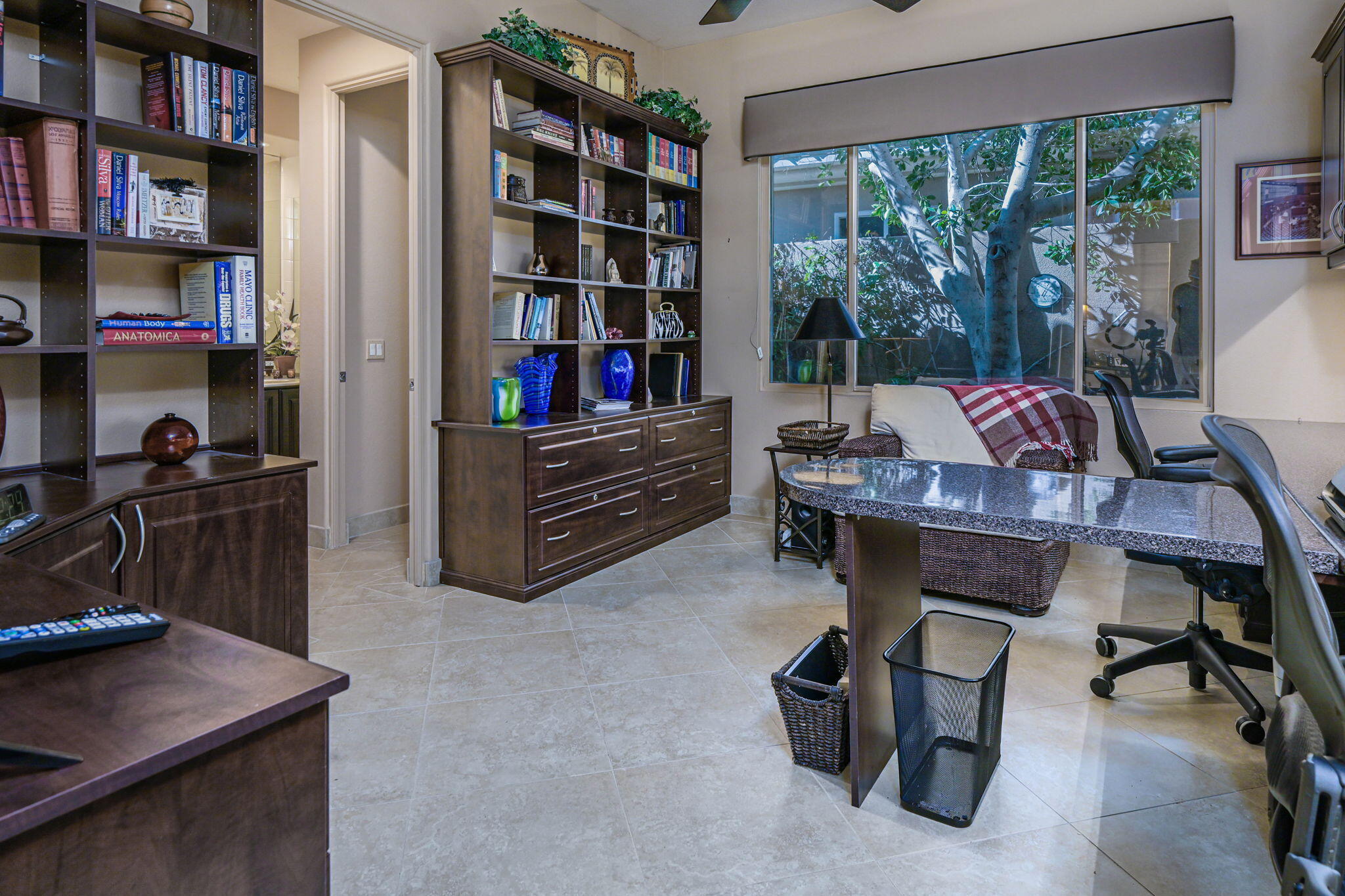 328 Tomahawk Drive Palm Desert, CA 92211 - Photo 23 of 56 a view of a workspace with furniture and a bookshelf