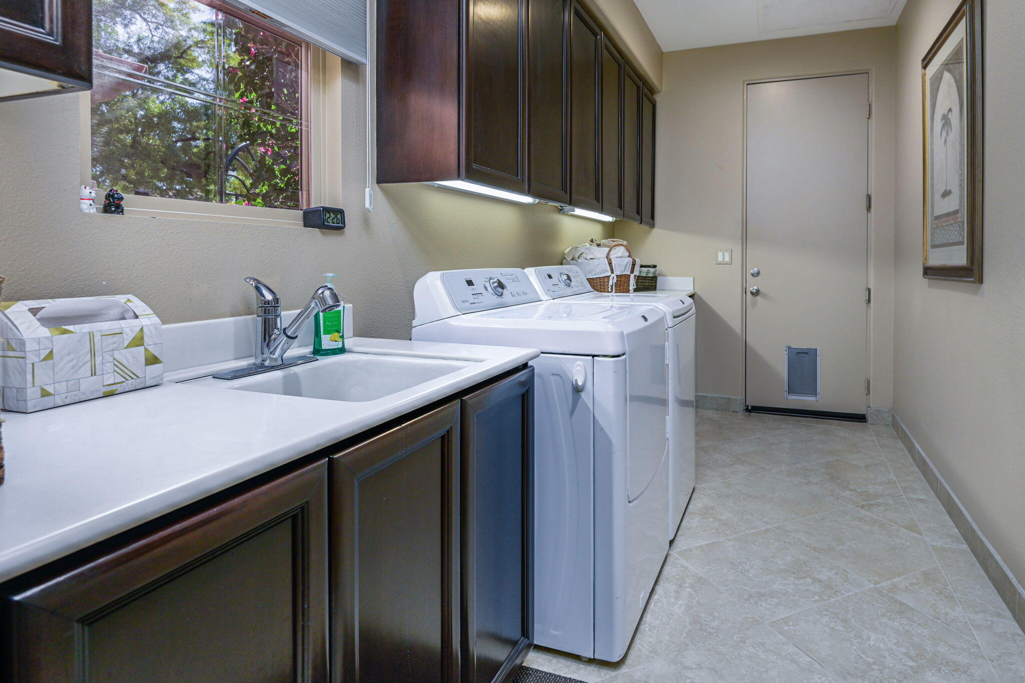 328 Tomahawk Drive Palm Desert, CA 92211 - Photo 26 of 56 a utility room with a sink a cabinetry and window