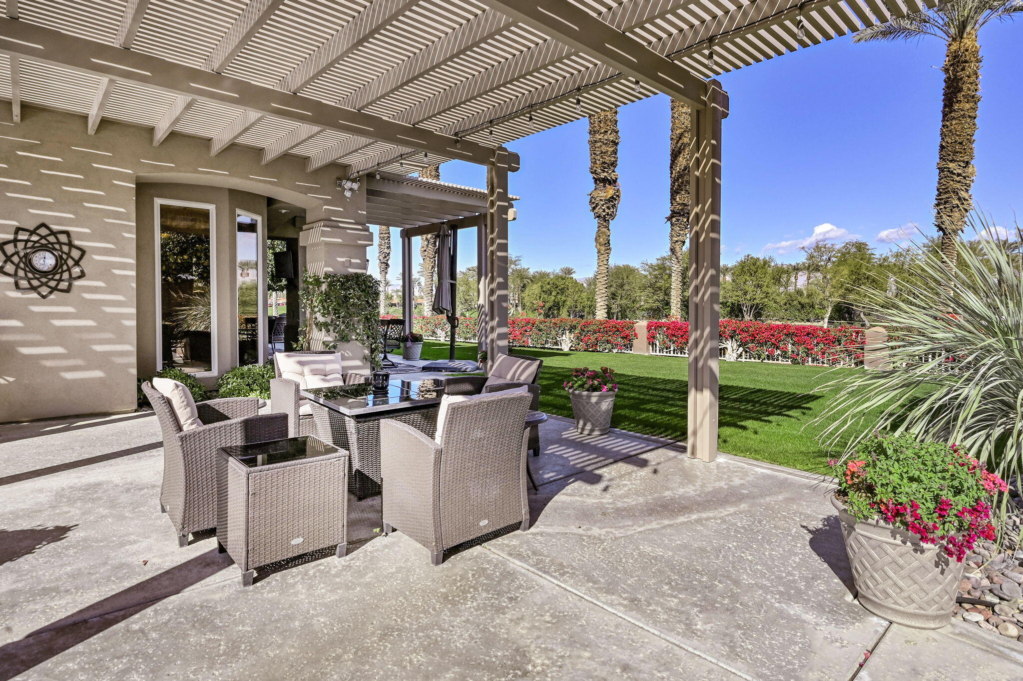 328 Tomahawk Drive Palm Desert, CA 92211 - Photo 31 of 56 a view of a patio with couches and table and chairs and potted plants