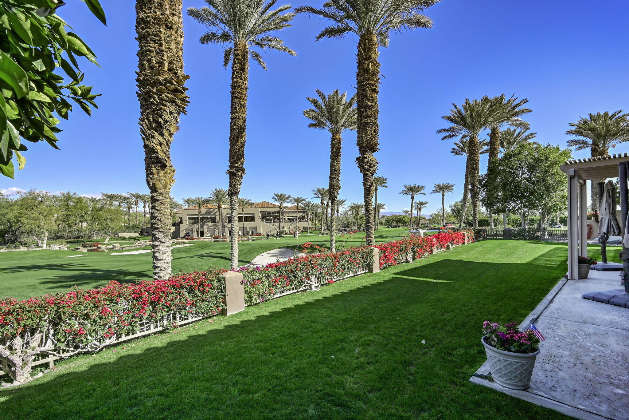 328 Tomahawk Drive Palm Desert, CA 92211 - Photo 38 of 56 a view of a garden with a building in the background