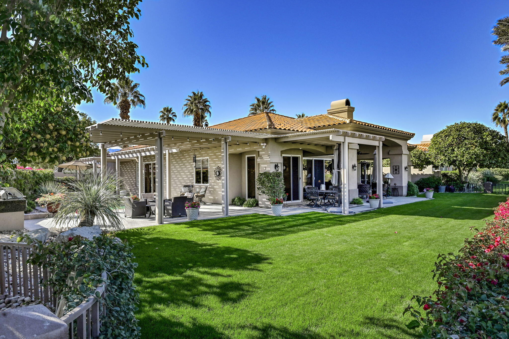328 Tomahawk Drive Palm Desert, CA 92211 - Photo 39 of 56 a view of a house with a yard deck and a large tree