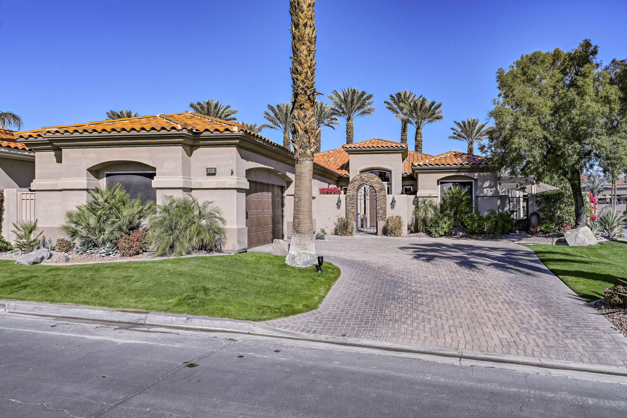 328 Tomahawk Drive Palm Desert, CA 92211 - Photo 51 of 56 a front view of a house with a yard and potted plants