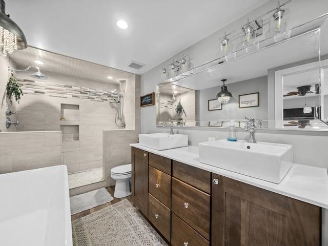 8294 North Leaf River Road Leaf River, IL 61047 - Photo 34 of 56 a spacious bathroom with a double vanity sink toilet and a mirror
