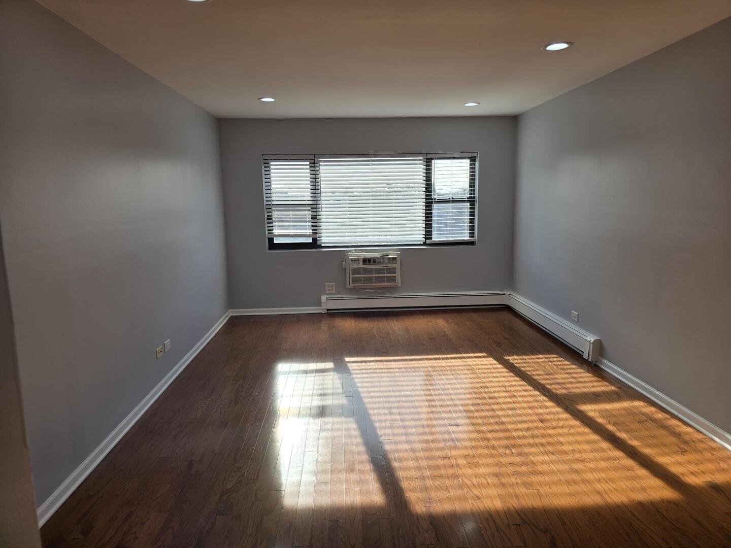 6400 North Ridge Boulevard, Unit 404 Chicago, IL 60626 - Photo 5 of 16 wooden floor in an empty room with a window