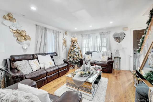 a living room with furniture hard wood floor and a flat screen tv