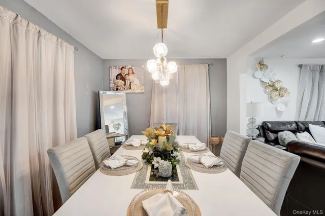 a dining room with furniture and a chandelier
