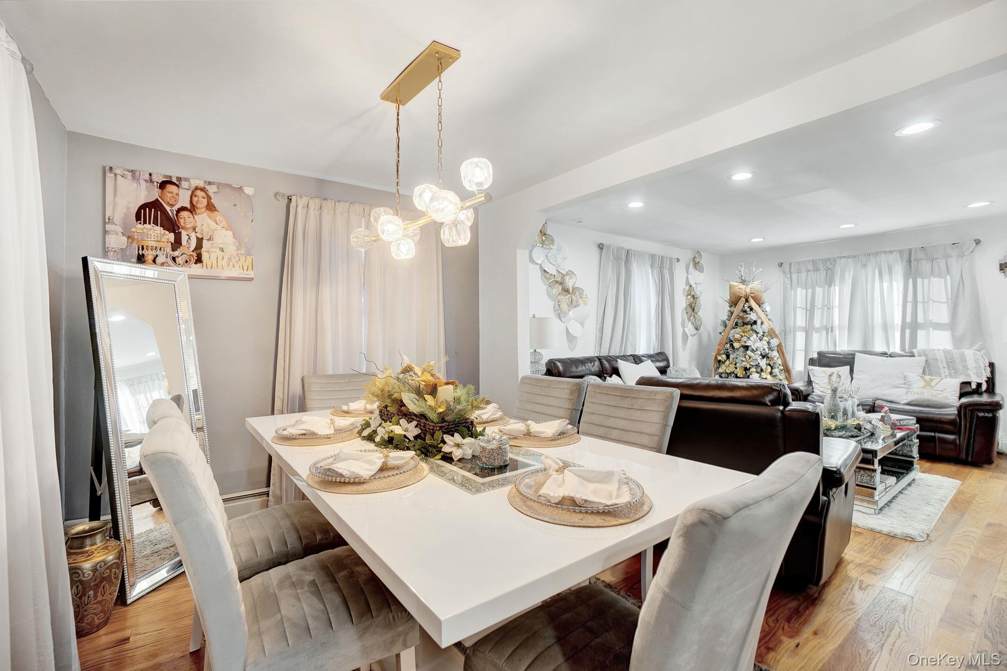 91 Cedar Road Amityville, NY 11701 - Photo 13 of 30 a view of a dining room with furniture and wooden floor