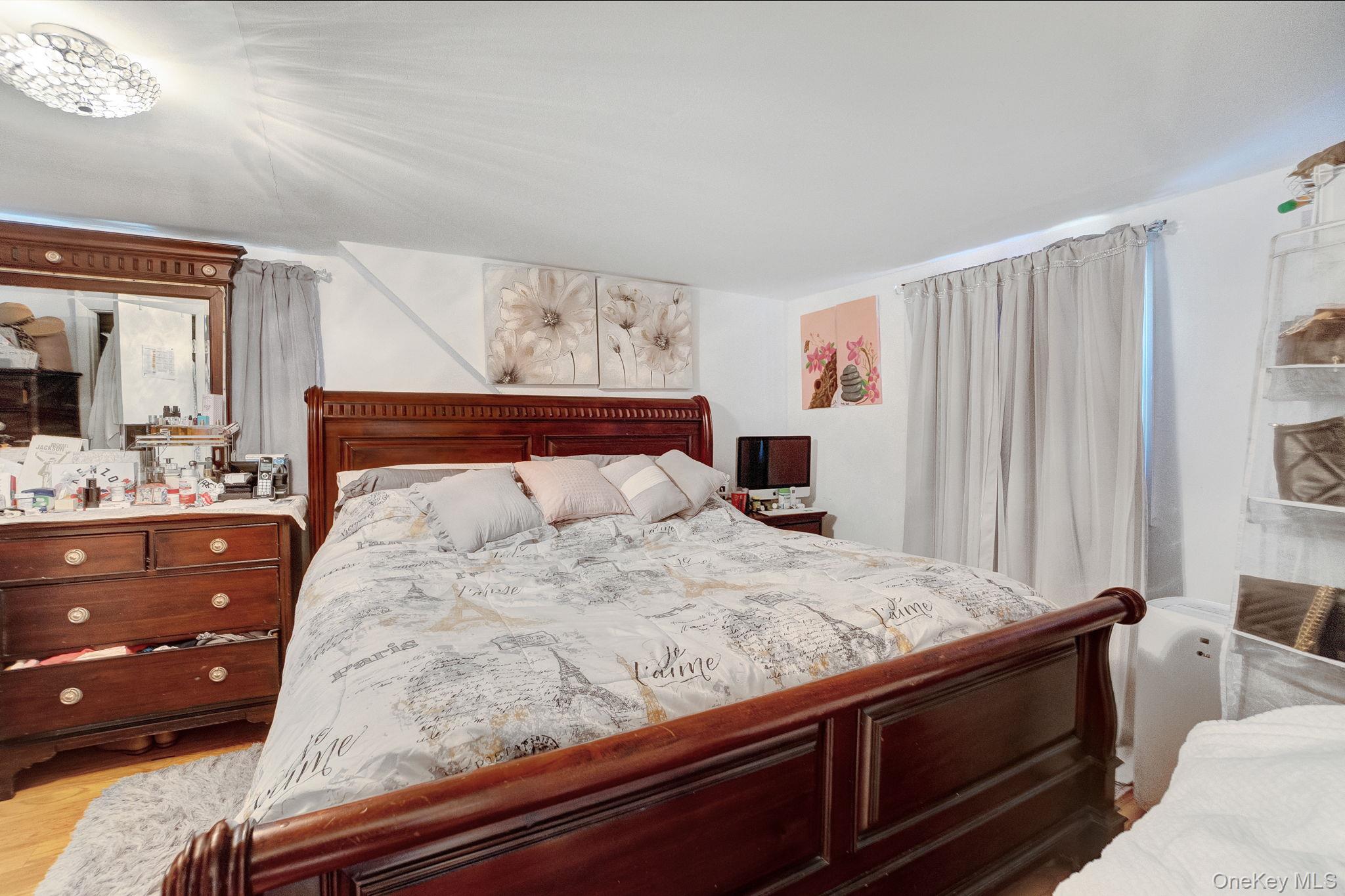 91 Cedar Road Amityville, NY 11701 - Photo 20 of 30 a bedroom with a bed and a dresser