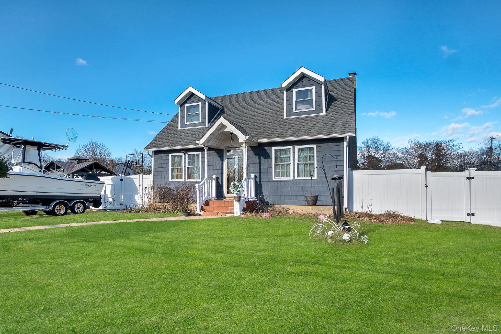 91 Cedar Road Amityville, NY 11701 - Photo 2 of 30 a front view of a house with a yard
