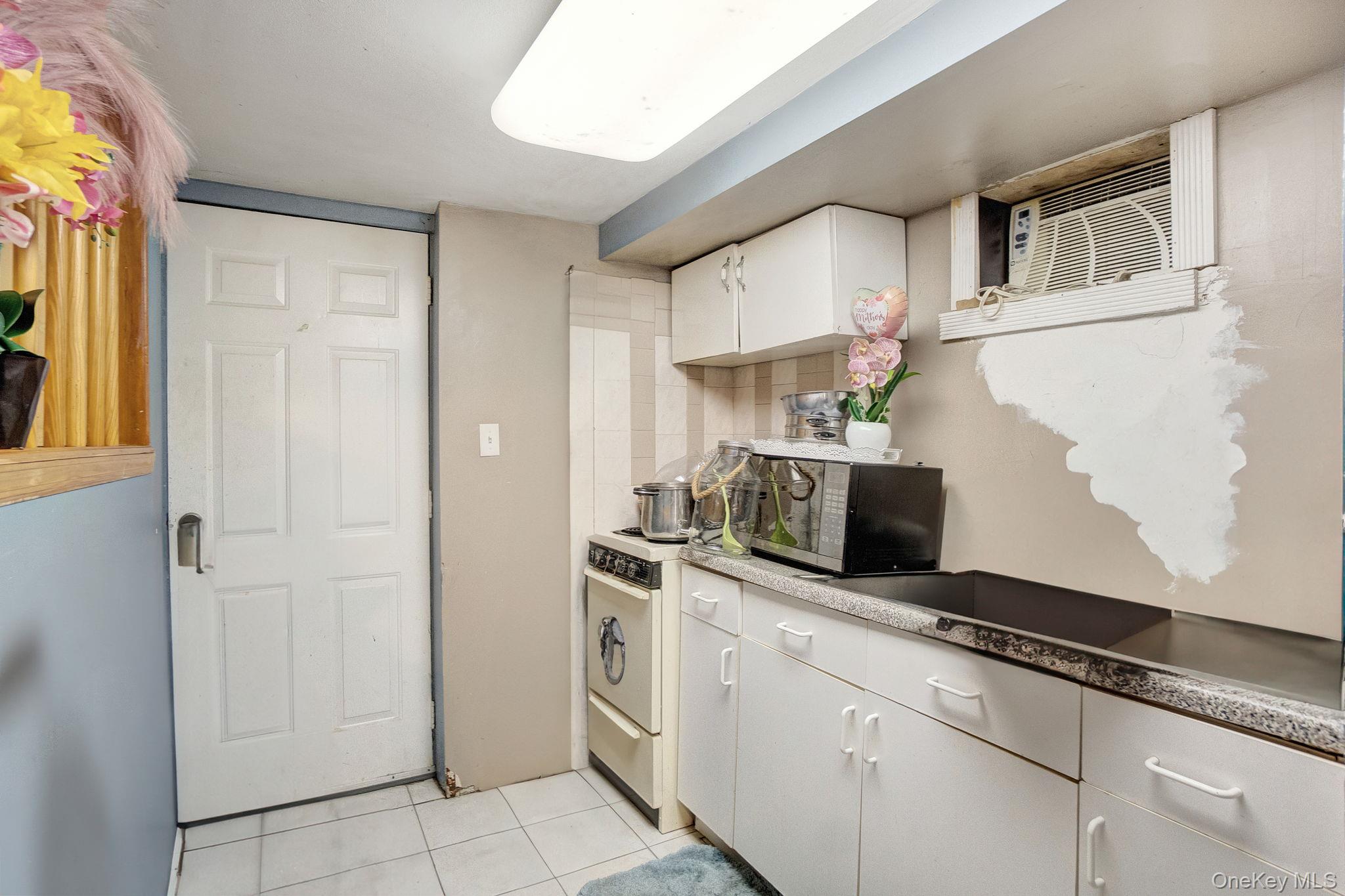 91 Cedar Road Amityville, NY 11701 - Photo 22 of 30 a kitchen with stainless steel appliances granite countertop a refrigerator and a stove