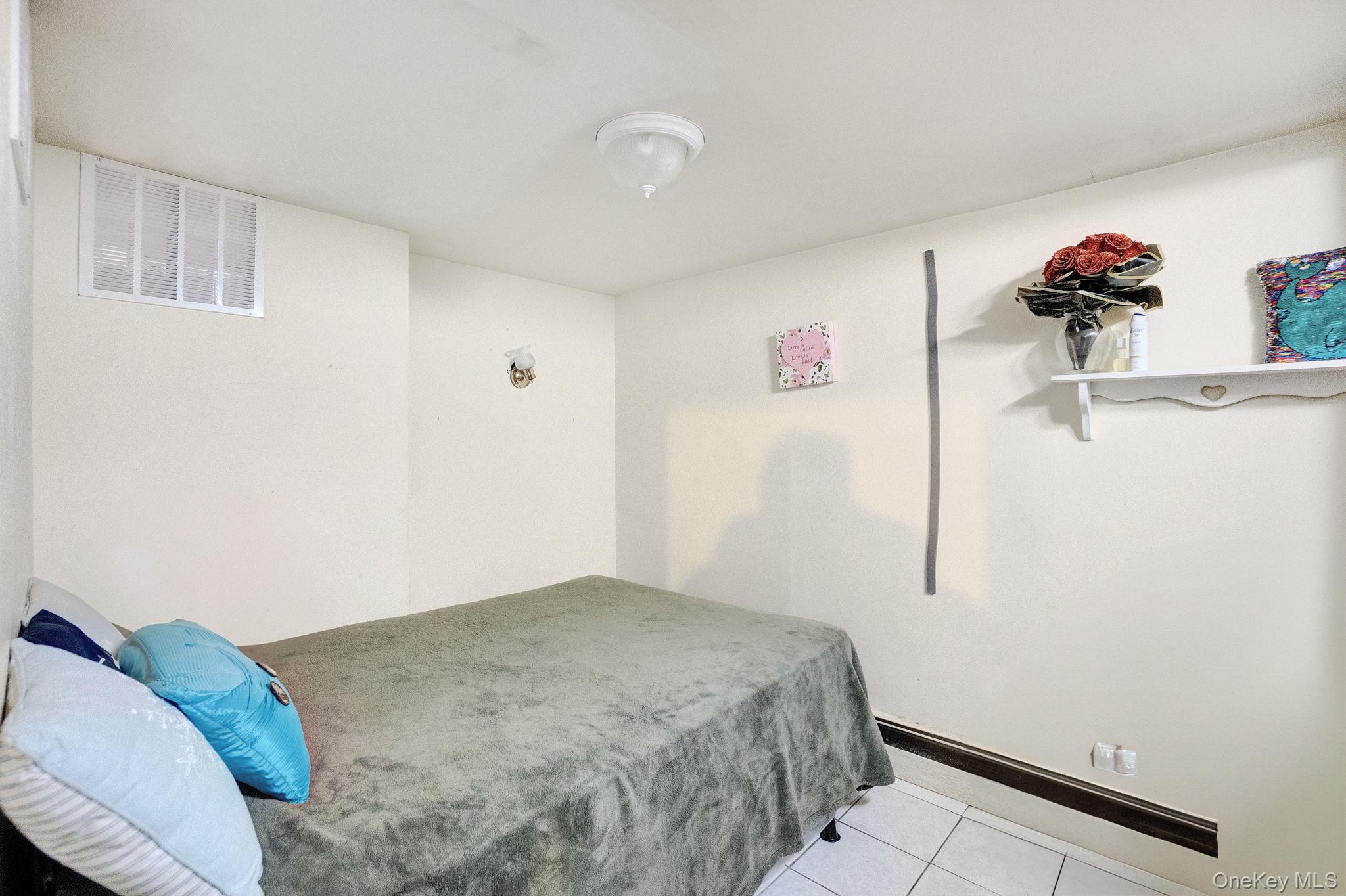 91 Cedar Road Amityville, NY 11701 - Photo 24 of 30 a bedroom with a bed and a dresser