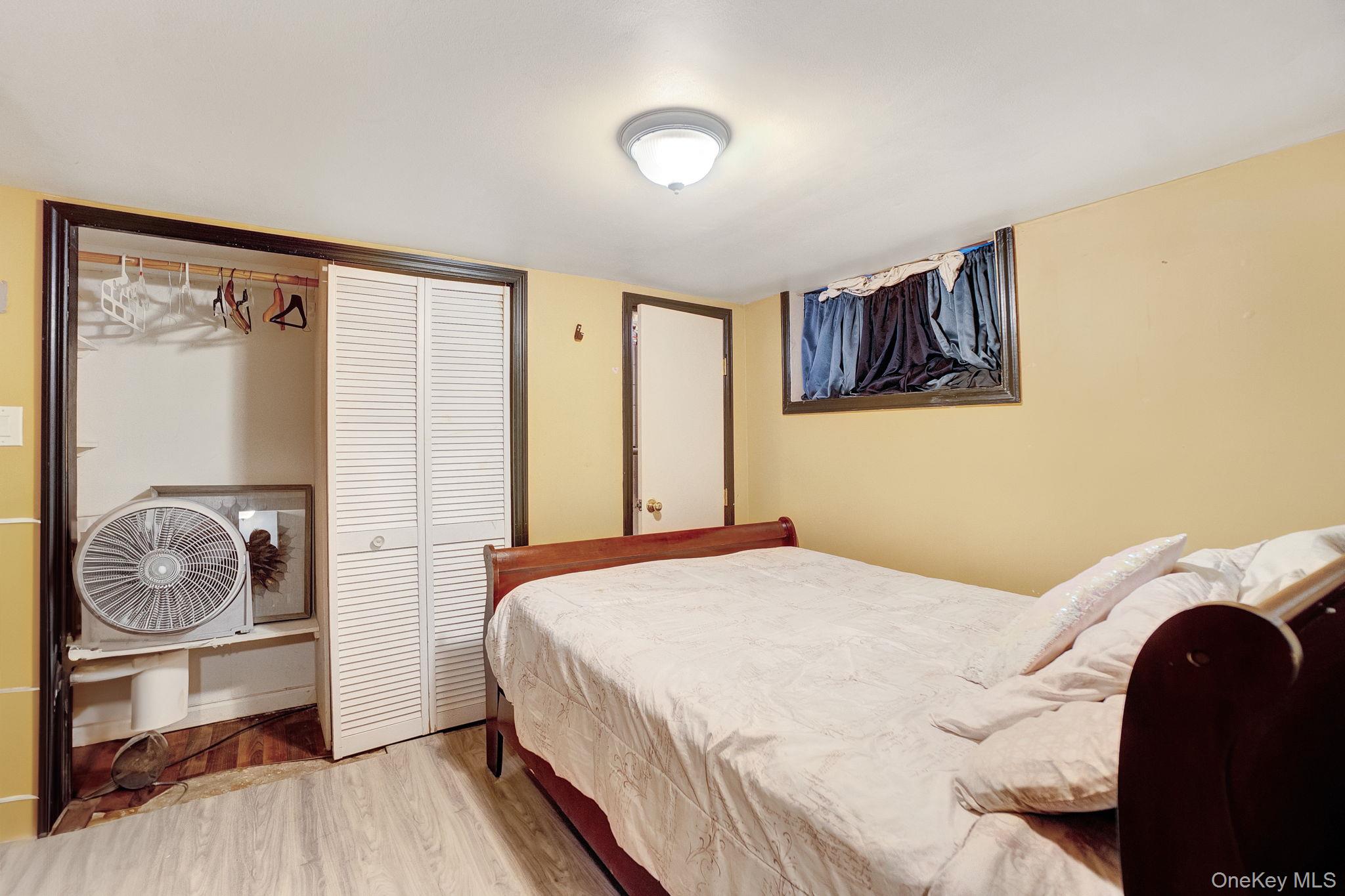 91 Cedar Road Amityville, NY 11701 - Photo 25 of 30 a bedroom with a bed and a window