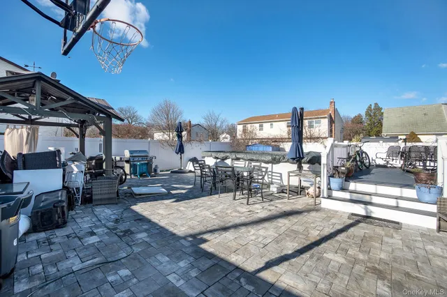 a view of a patio with a table and chairs