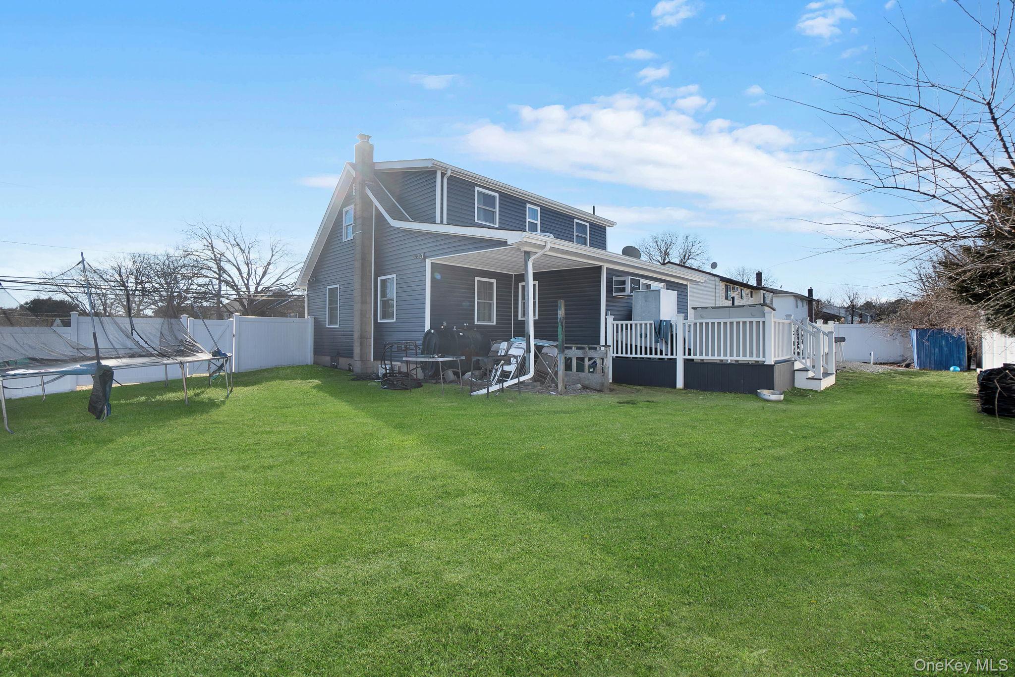 91 Cedar Road Amityville, NY 11701 - Photo 30 of 30 a view of a house with a big yard and large trees