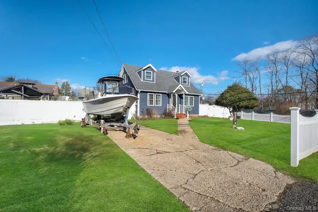 a front view of a house with a yard fire pit and chairs