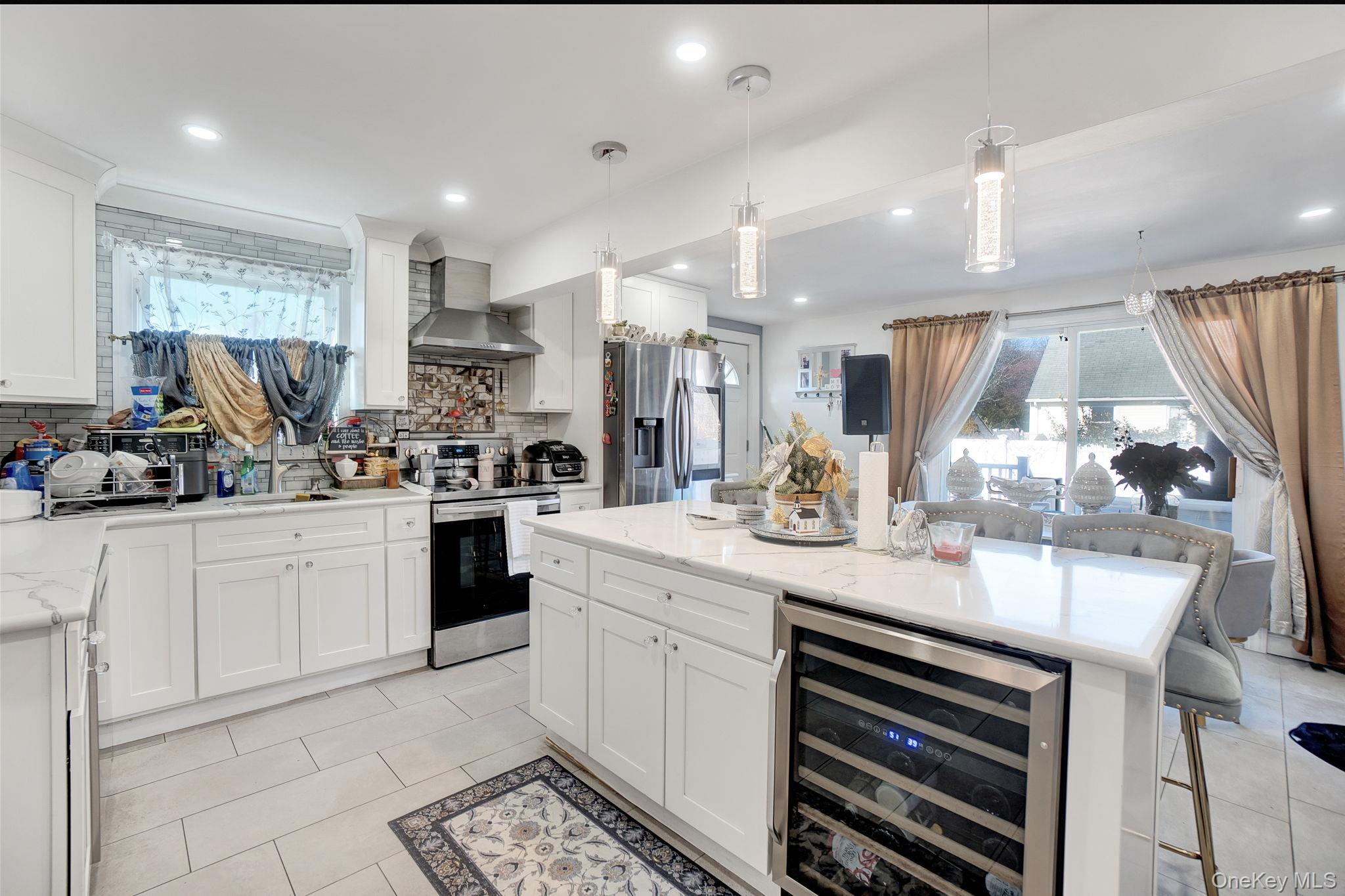 91 Cedar Road Amityville, NY 11701 - Photo 4 of 30 a kitchen with a sink stainless steel appliances and cabinets