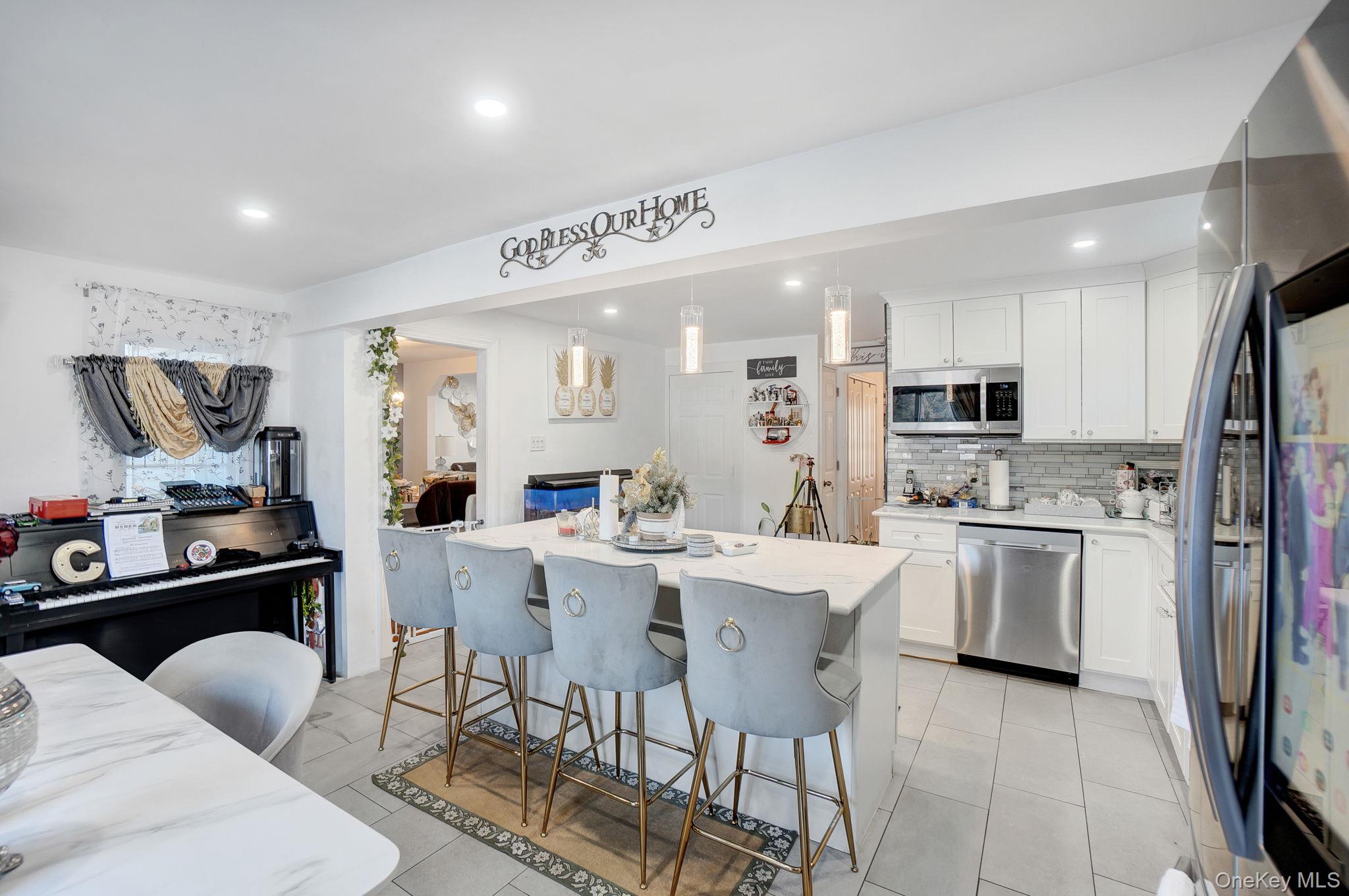 91 Cedar Road Amityville, NY 11701 - Photo 5 of 30 a kitchen with stainless steel appliances kitchen island granite countertop a sink and cabinets
