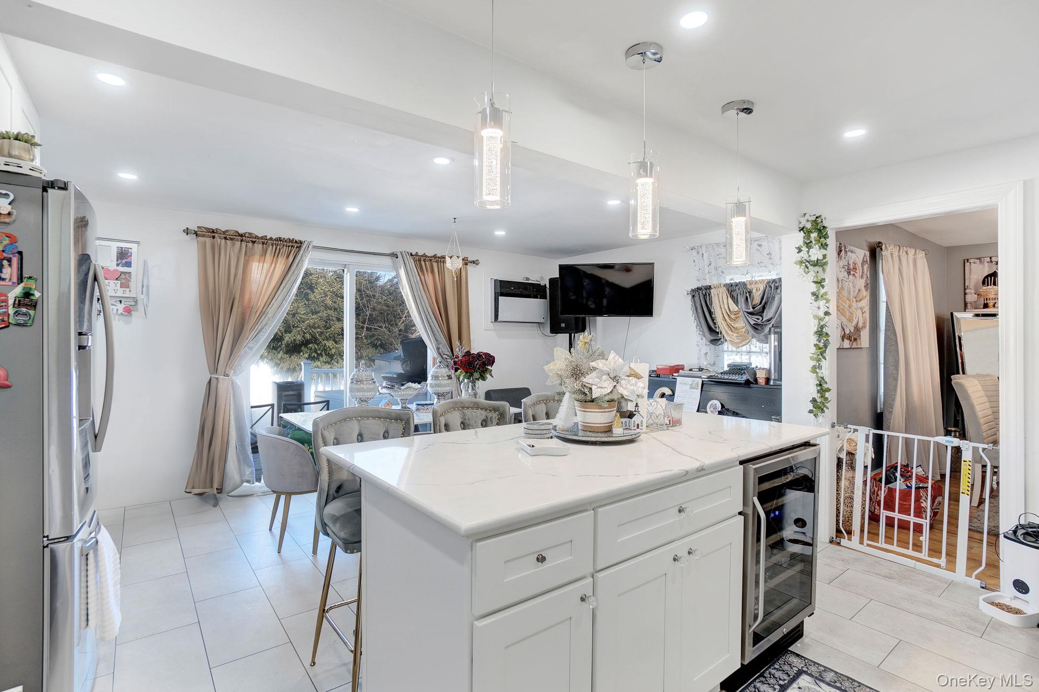 91 Cedar Road Amityville, NY 11701 - Photo 6 of 30 a room with stainless steel appliances kitchen island granite countertop a refrigerator and a sink