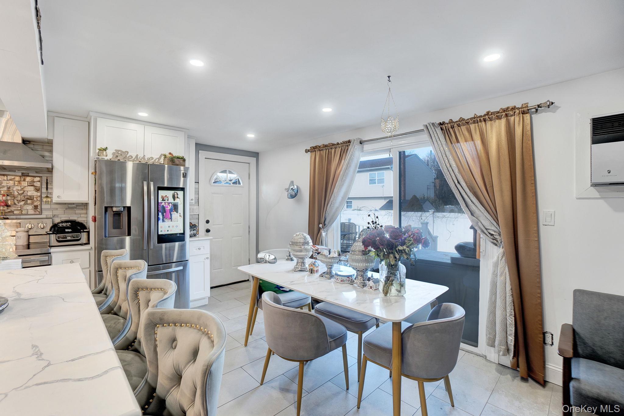 91 Cedar Road Amityville, NY 11701 - Photo 7 of 30 a view of a dining room with furniture