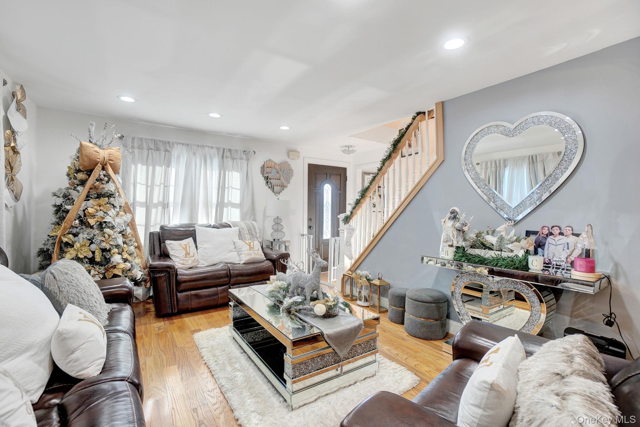91 Cedar Road Amityville, NY 11701 - Photo 10 of 30 a living room with furniture and a chandelier