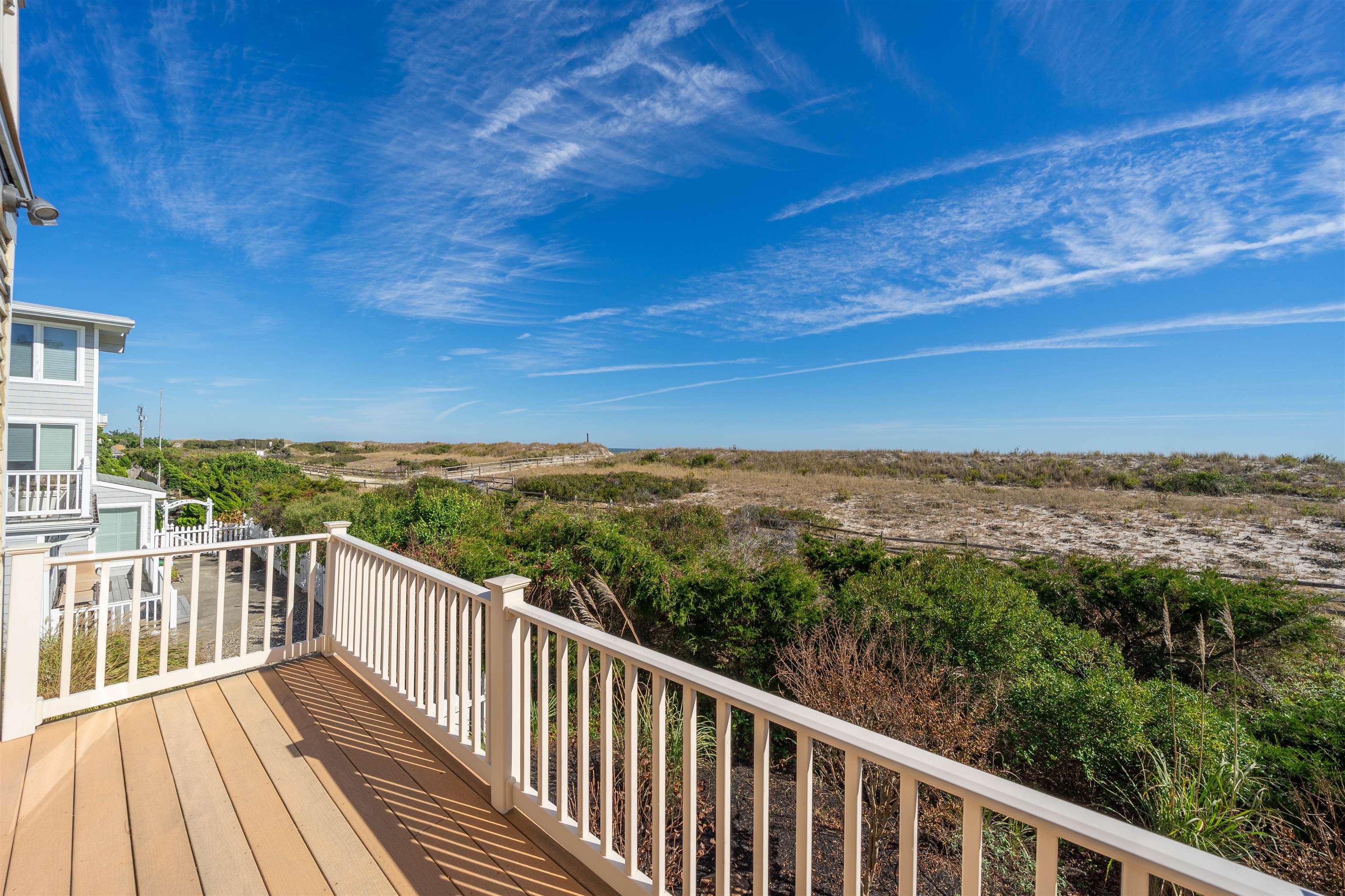 83 13th Street East Avalon, NJ 08202 - Photo 11 of 40 a view of a balcony with wooden floor and fence