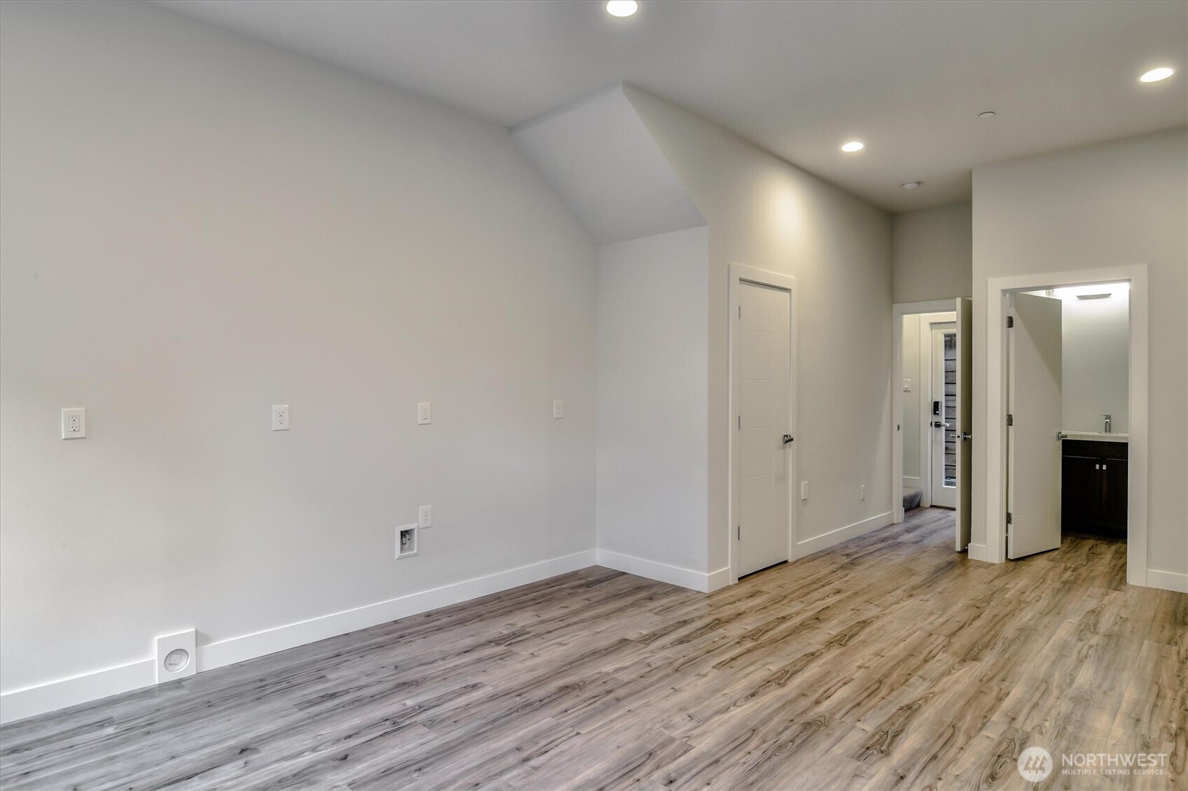1919 24th Avenue South, Unit D Seattle, WA 98144 - Photo 12 of 35 a view of an empty room with wooden floor and closet