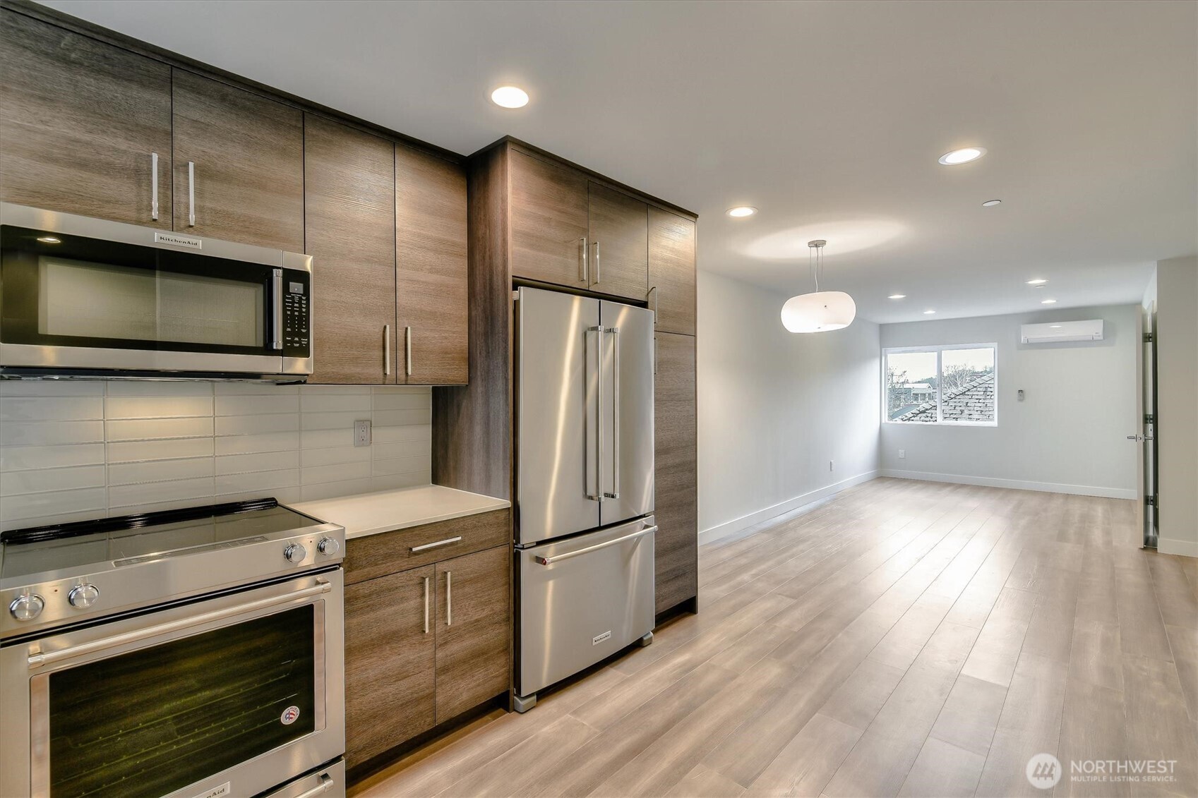 1919 24th Avenue South, Unit D Seattle, WA 98144 - Photo 18 of 35 a kitchen with stainless steel appliances wooden cabinets and stove