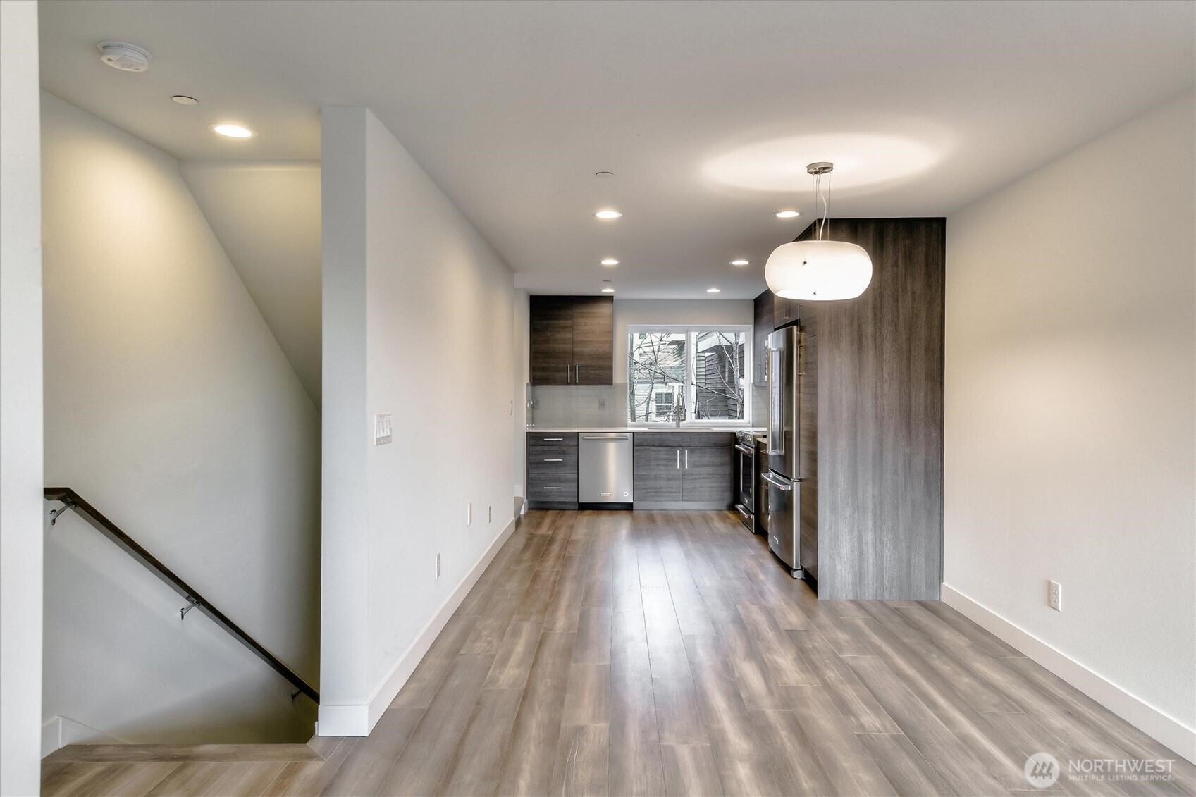 1919 24th Avenue South, Unit D Seattle, WA 98144 - Photo 9 of 35 a view of a kitchen with wooden floor and a window