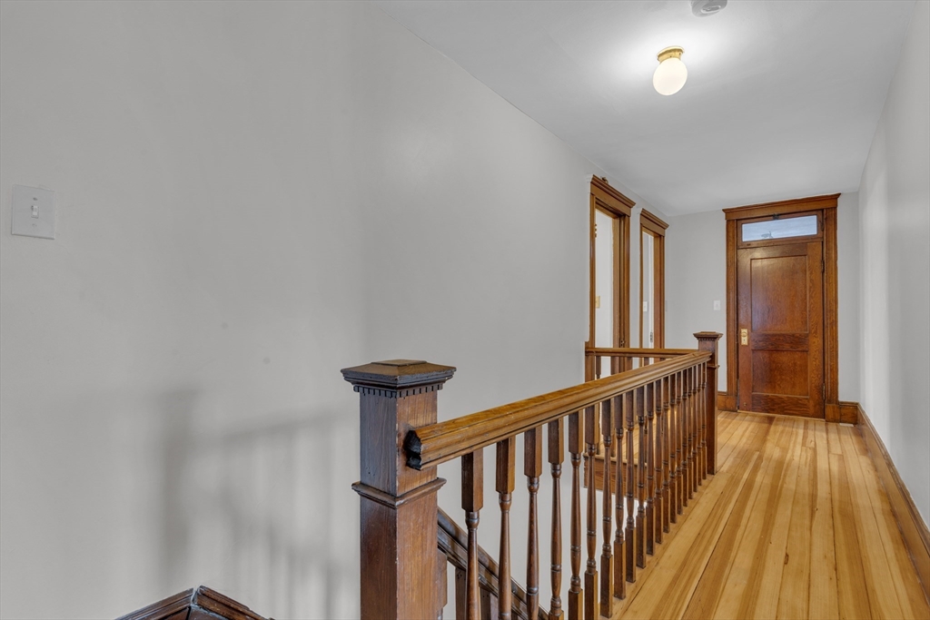 64 Commonwealth Road Watertown, MA 02472 - Photo 23 of 23 a view of a hallway with wooden floor and staircase