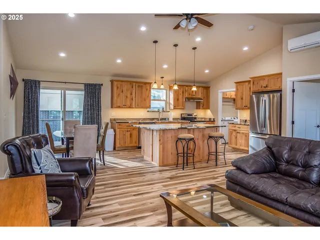 a living room kitchen with furniture and a view of kitchen
