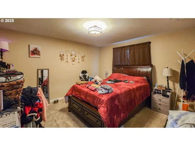 a bedroom with a bed and a tv in it