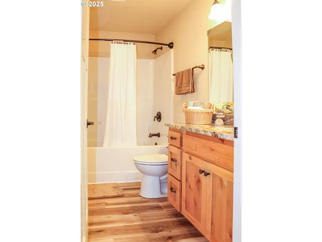 a bathroom with a sink a toilet and shower curtain