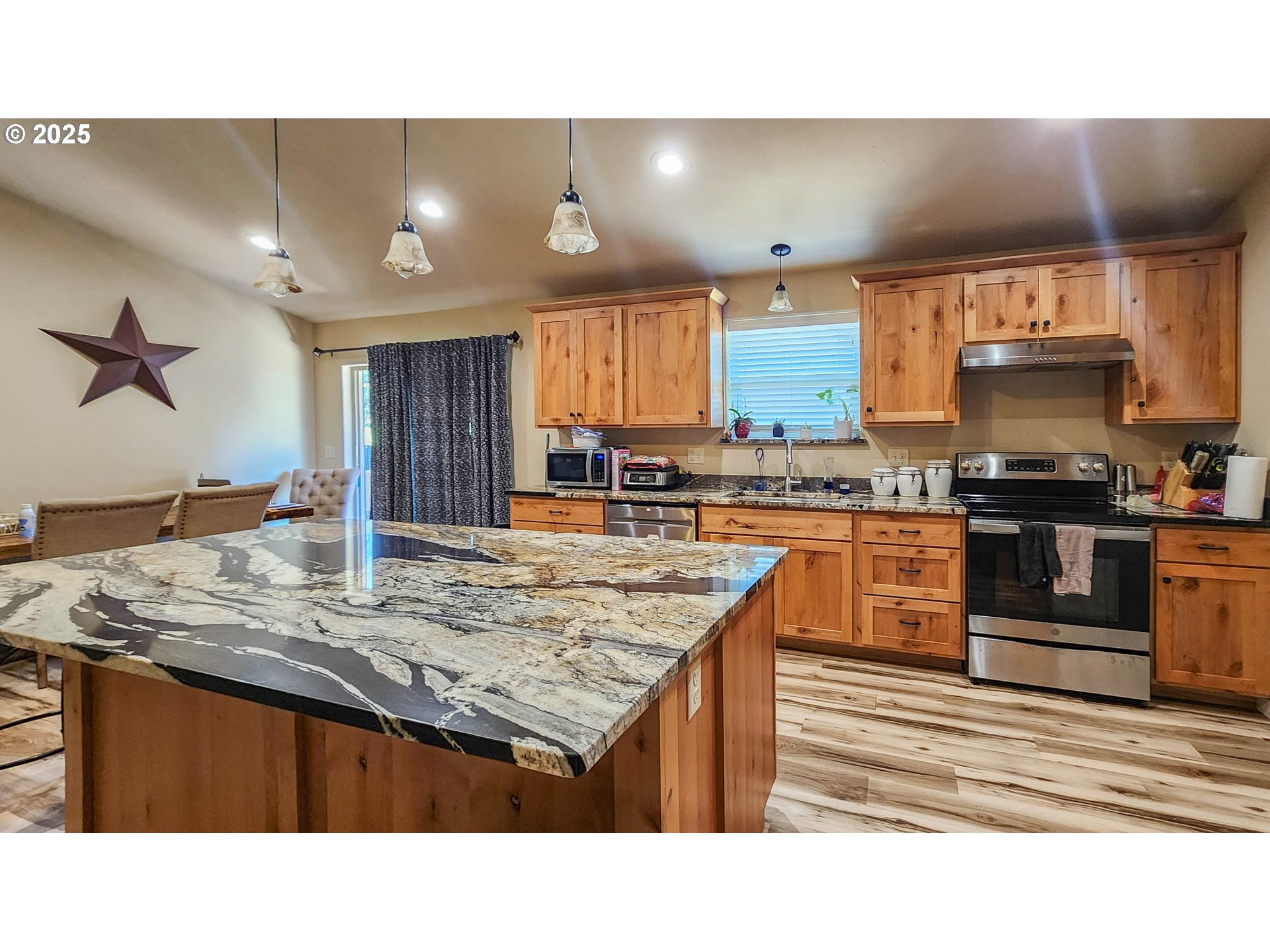 5135 Southwest Grange Road Roseburg, OR 97471 - Photo 7 of 27 a kitchen with a stove a sink and a refrigerator