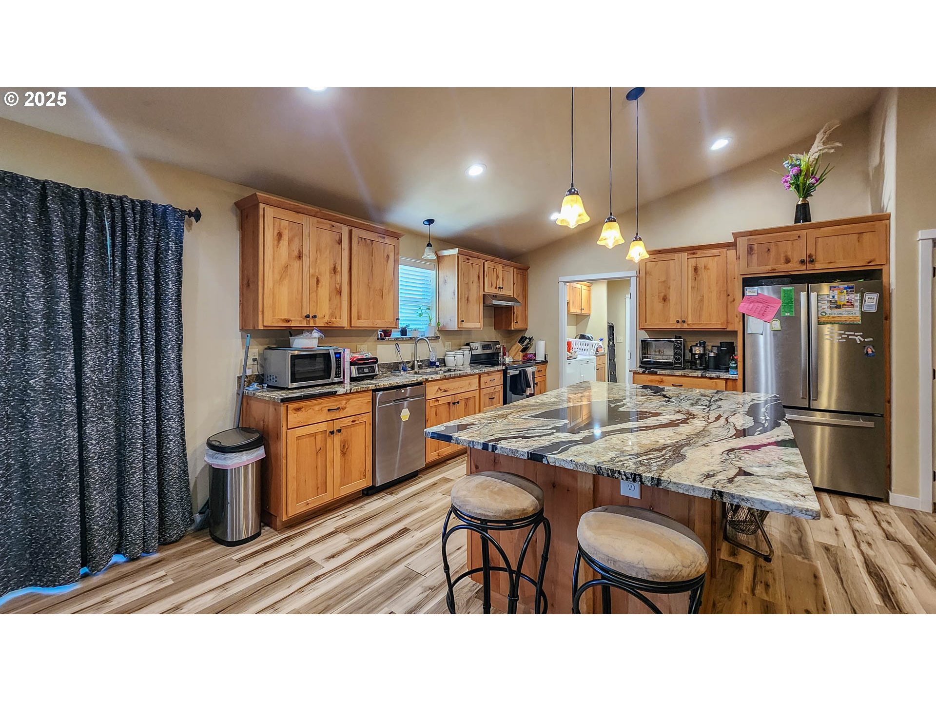 5135 Southwest Grange Road Roseburg, OR 97471 - Photo 8 of 27 a kitchen with stainless steel appliances kitchen island granite countertop a sink refrigerator and cabinets