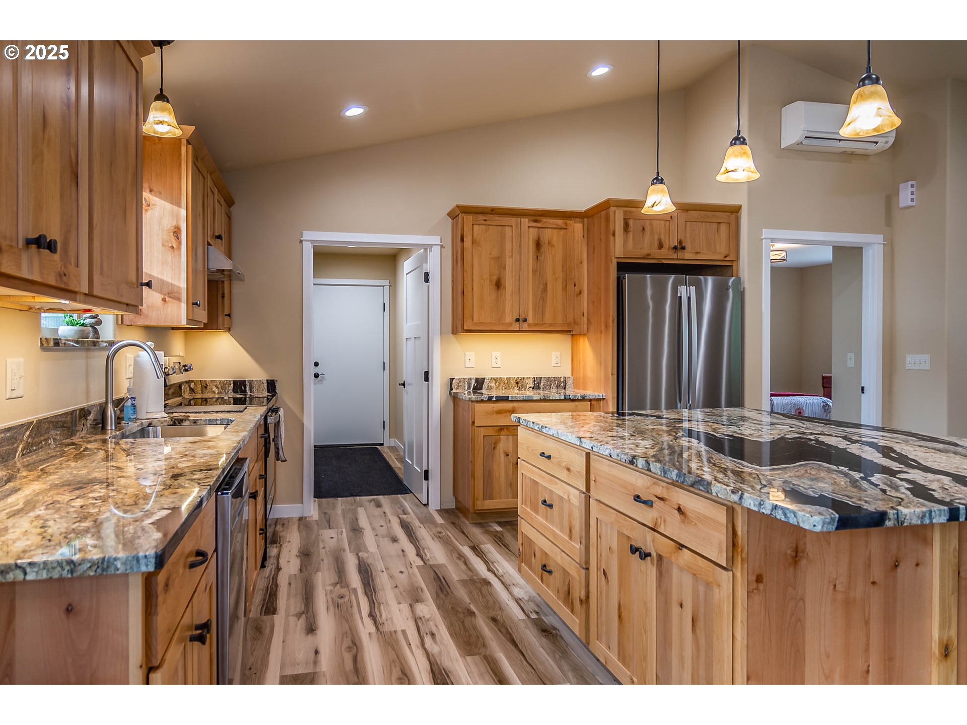 5135 Southwest Grange Road Roseburg, OR 97471 - Photo 9 of 27 a kitchen with kitchen island granite countertop a sink stove and refrigerator