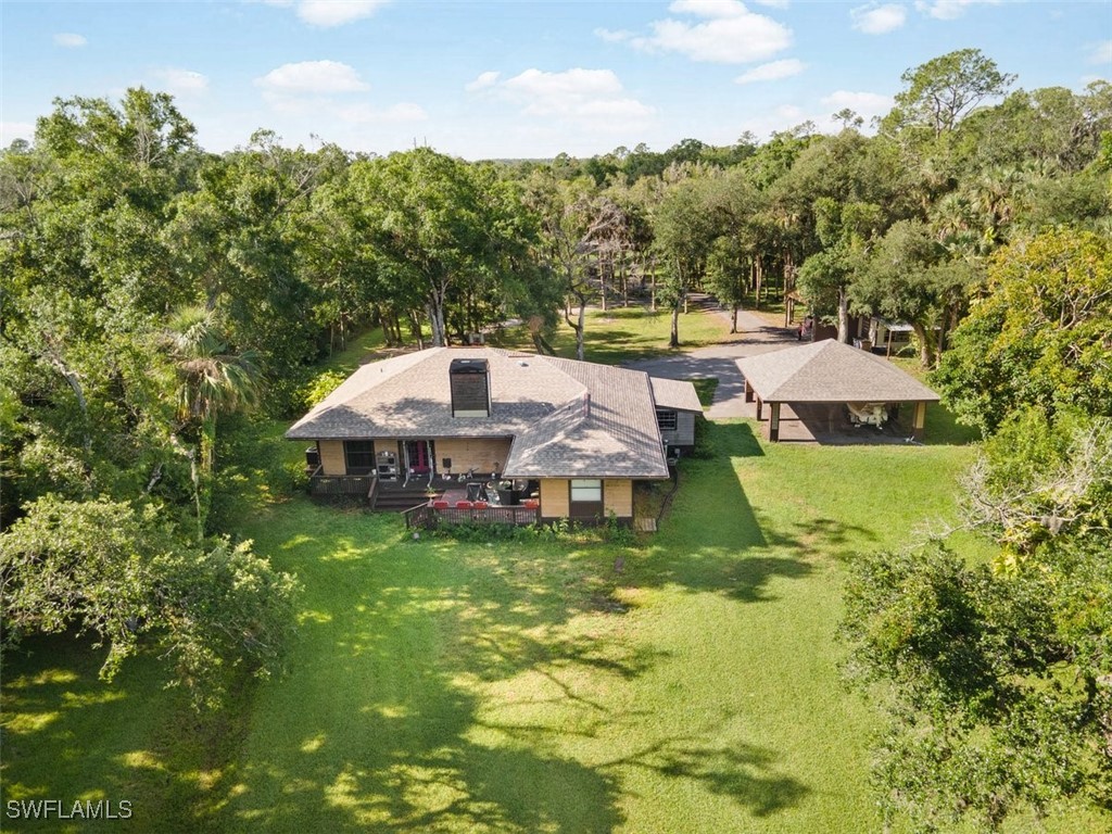 17321 Oak Creek Road Alva, FL 33920 - Photo 2 of 34 a aerial view of a house with swimming pool and green space