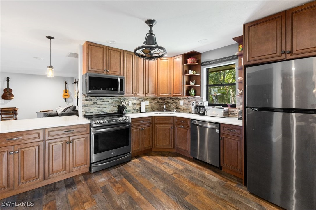 17321 Oak Creek Road Alva, FL 33920 - Photo 29 of 34 a kitchen with a sink stainless steel appliances and cabinets