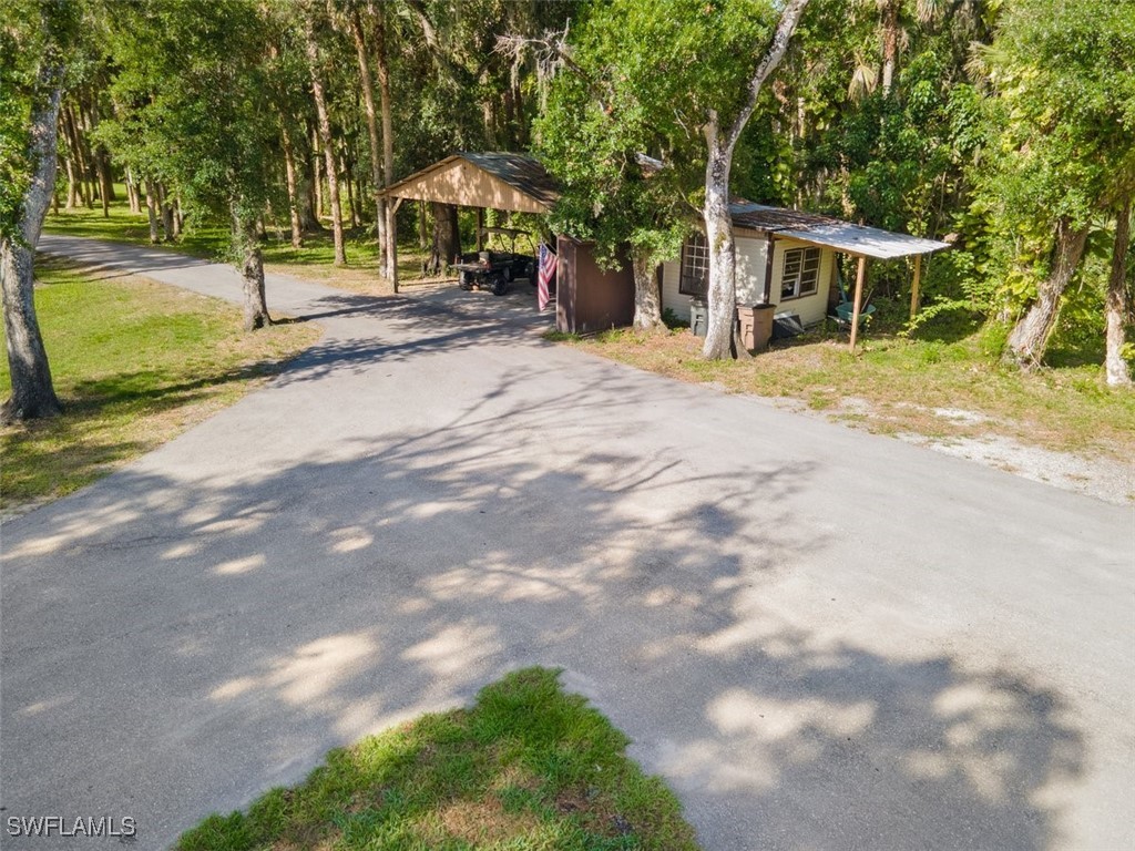 17321 Oak Creek Road Alva, FL 33920 - Photo 3 of 34 a view of a house with a yard and sitting area