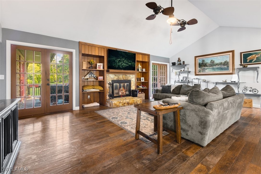 17321 Oak Creek Road Alva, FL 33920 - Photo 32 of 34 a living room with furniture a flat screen tv and a floor to ceiling window