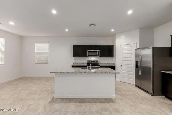 a kitchen with a refrigerator microwave and sink