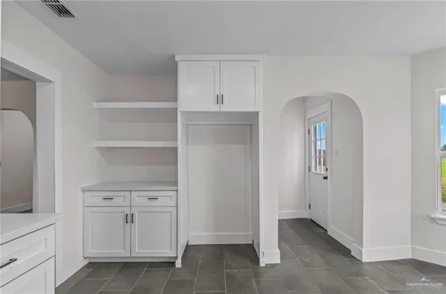 wooden floor with white cabinets and wooden floor
