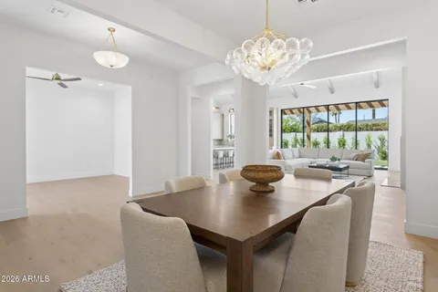 a view of a dining room with a table and chairs