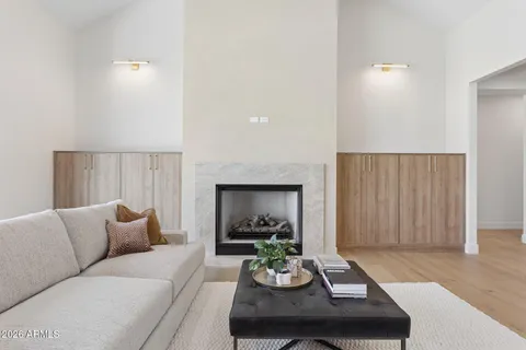 a living room with furniture and a wooden floor