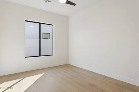 an empty room with windows and closet