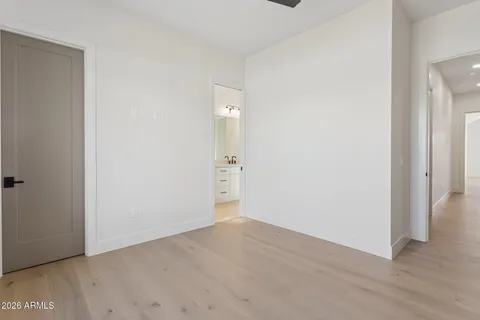 a view of an empty room with window and closet area