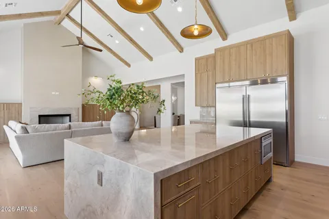 a kitchen with stainless steel appliances granite countertop a sink a refrigerator and a stove