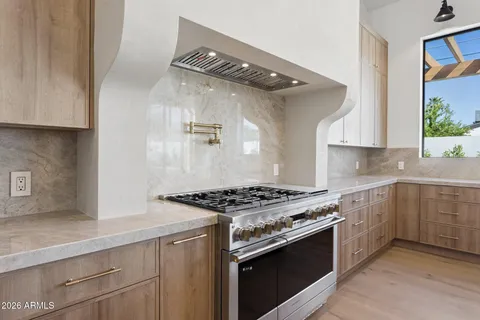 a kitchen with stainless steel appliances granite countertop a stove and a sink