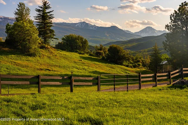 a view of a livingroom with furniture and floor to ceiling window