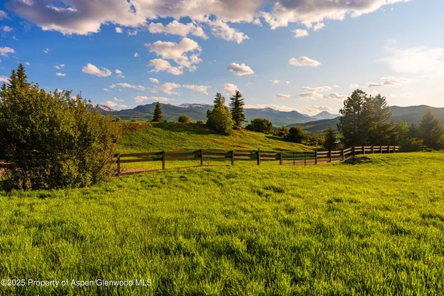 a table and chairs with the view of outdoor space