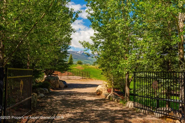 a living room with kitchen view and a large window